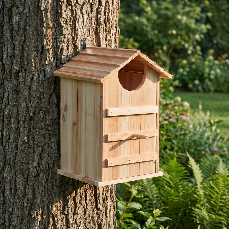 Owl house mounted on an oak trunk in a garden